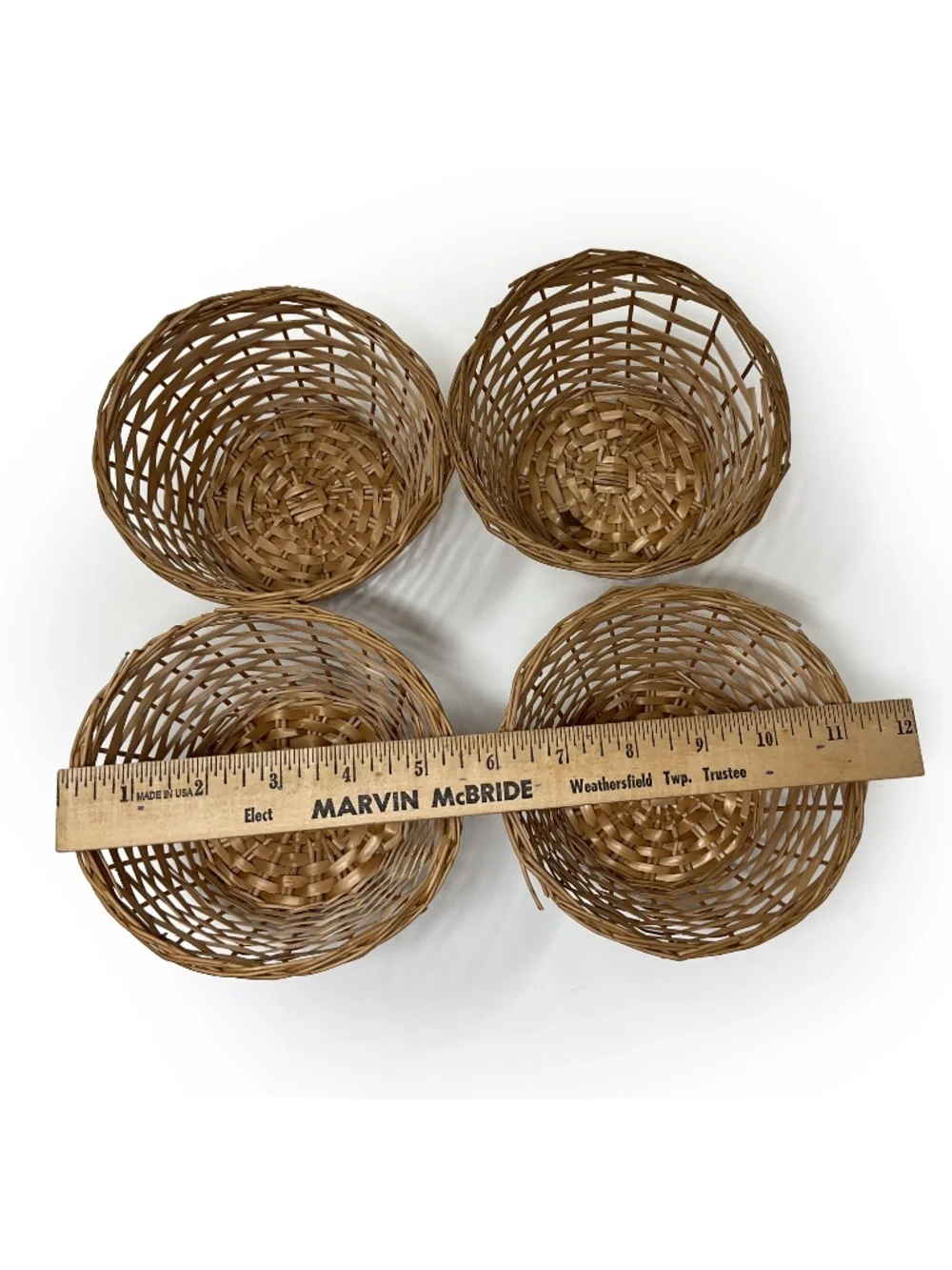 four small vintage round wicker woven wicker baskets with an open-lattice design